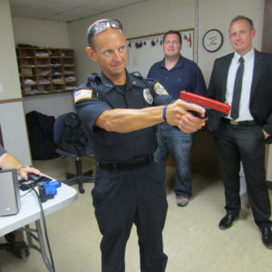 Officer Matt Hoza looked for the perpetrator during a school shooting training scenario. Assistant City Manager Ryan Heiland and City Manager Greg McDanel observed.