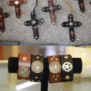 Mayes used belt ends to make leather crosses and bracelets.