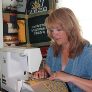 Angela Farrell sewed the sashing fabric around each block.