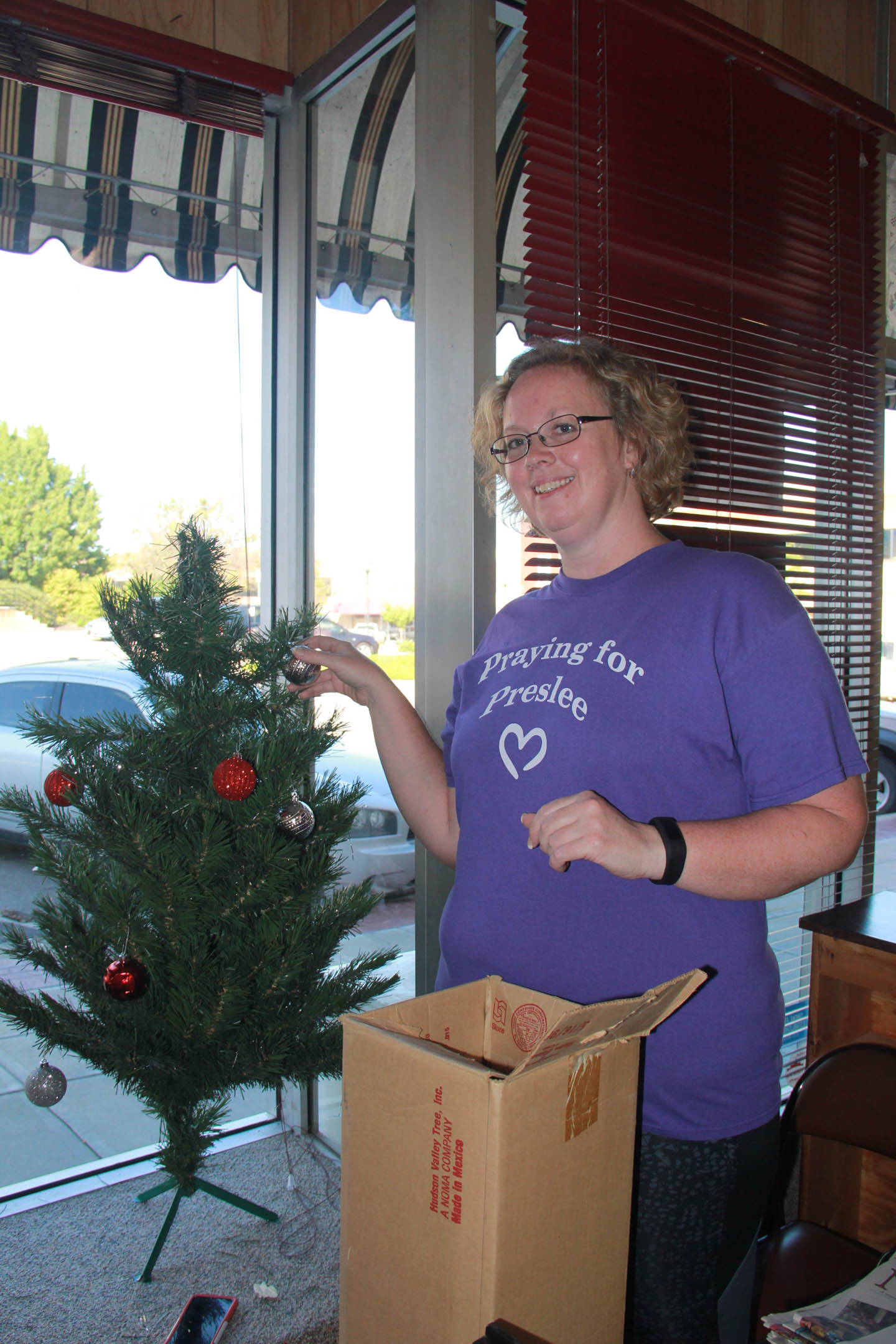 Amanda Gilman, Today’s Civic Women, decorates the Toys for Tots Christmas tree in the Nodaway News Leader’s window. Last year, 261 local children received gifts from the program organized by Today’s Civic Women. Community members may drop off new toys at any local donation bin. For each toy donated at the Nodaway News Leader office, you’ll receive $5 off any annual Nodaway News Leader subscription. 